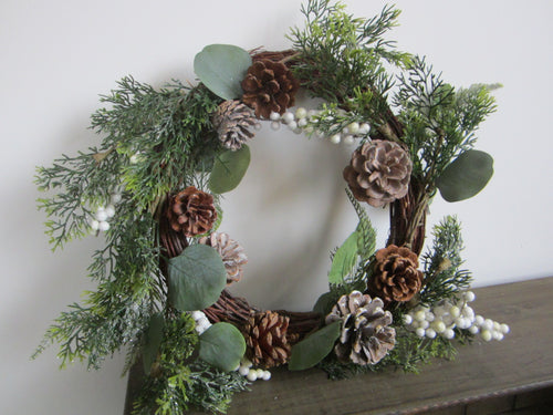 Christmas wreath with pine cones/white berries