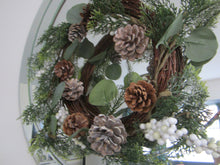 Christmas wreath with pine cones/white berries